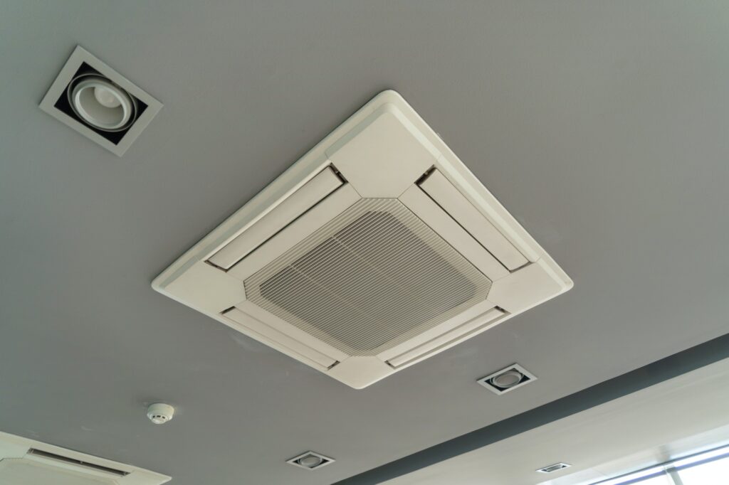 Ceiling mounted cassette type air conditioner in building system work. Ventilation compressor.